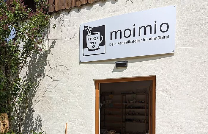 Der Hauseingang mit dem Schild Moimio ist zu sehen.