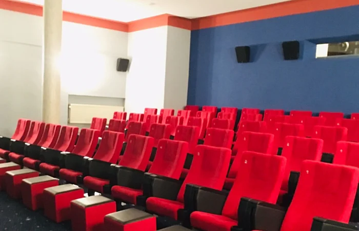 Rote Kinostühle mit roten Hockern und Galaxie Boden.